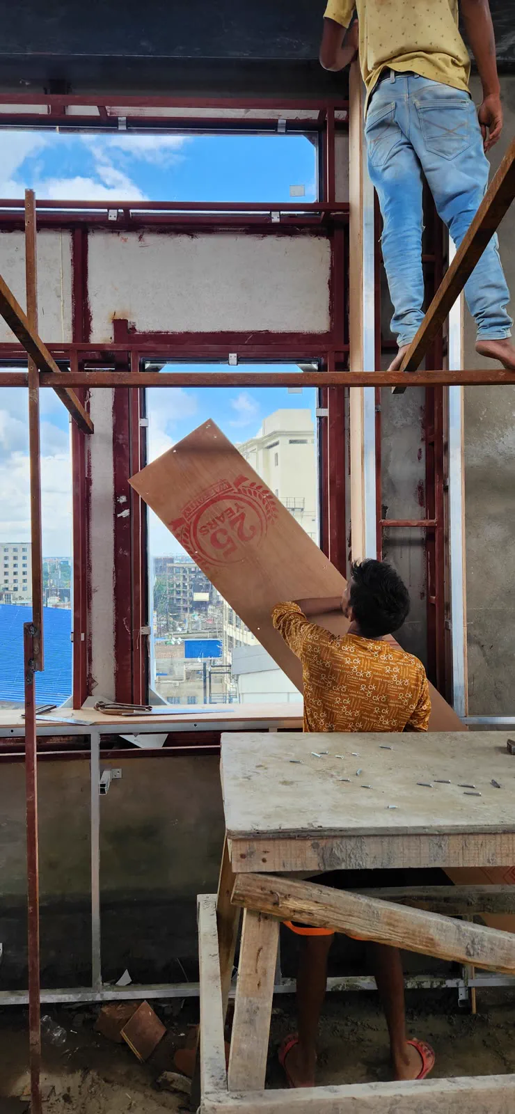 Arched window frames being installed