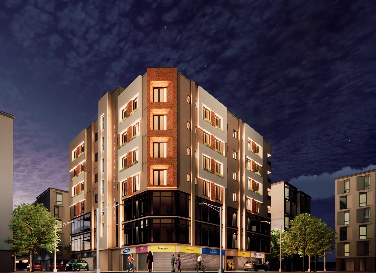 4no. Blackburn Rd at night, the lit brick stair core and glazed commercial floors on the corner