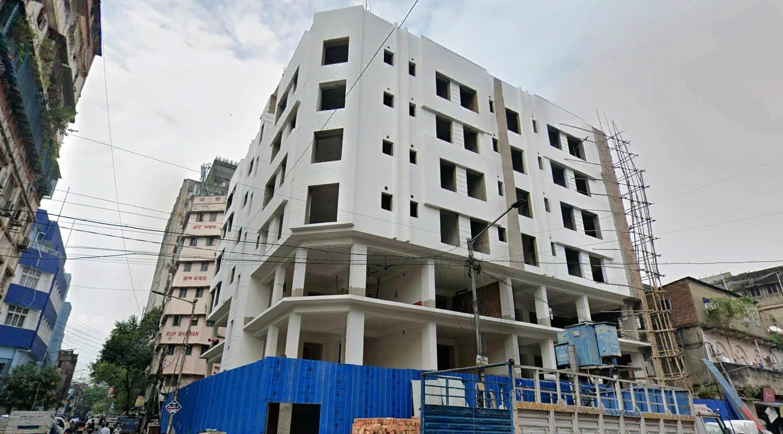 The long side elevation at the same stage, scaffolding still standing at the far end — Google Street View capture