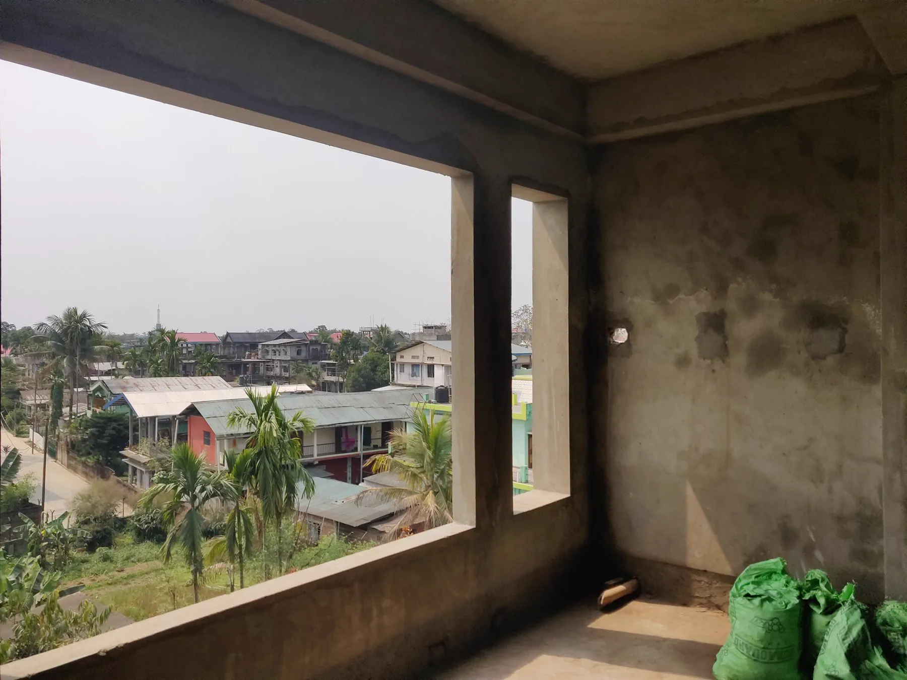 The view out of an unfinished city-side room over the town