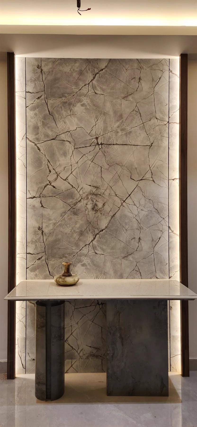 The console built on site, its marble slab lit from behind