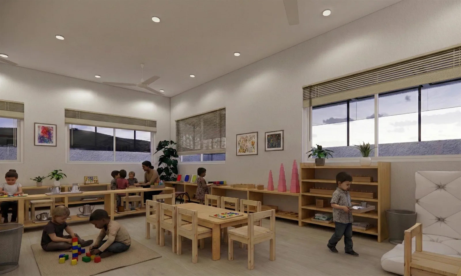A corner of the primary environment at Little Miracles &mdash; floor work on a mat, table work alongside it, and low shelves within reach