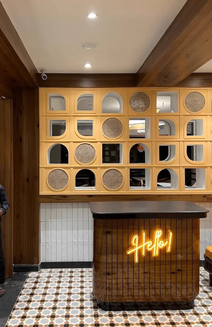Windsong Cafe's jaali wall — backlit niches with rattan inserts, built to the detail drawing