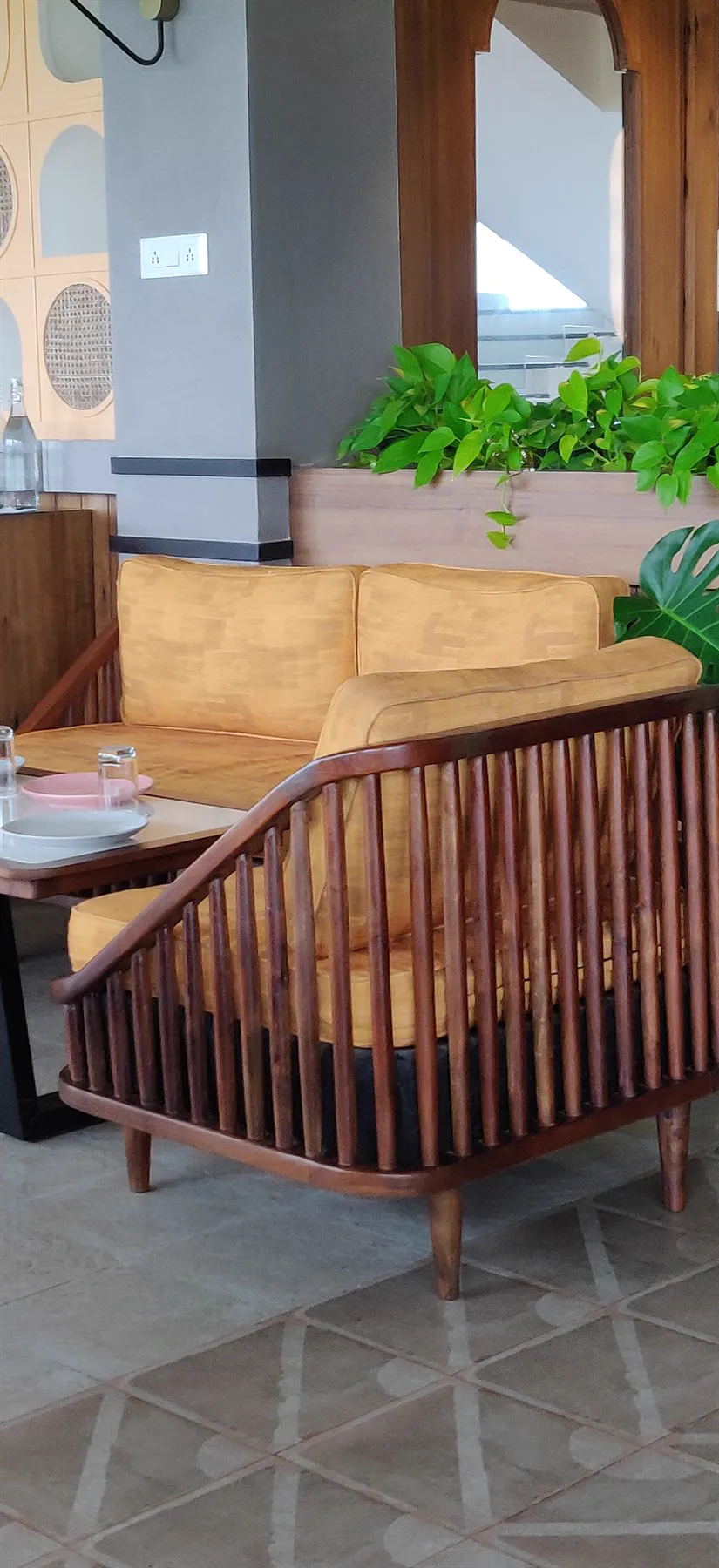 A pair of spindle-framed settees around a marble table