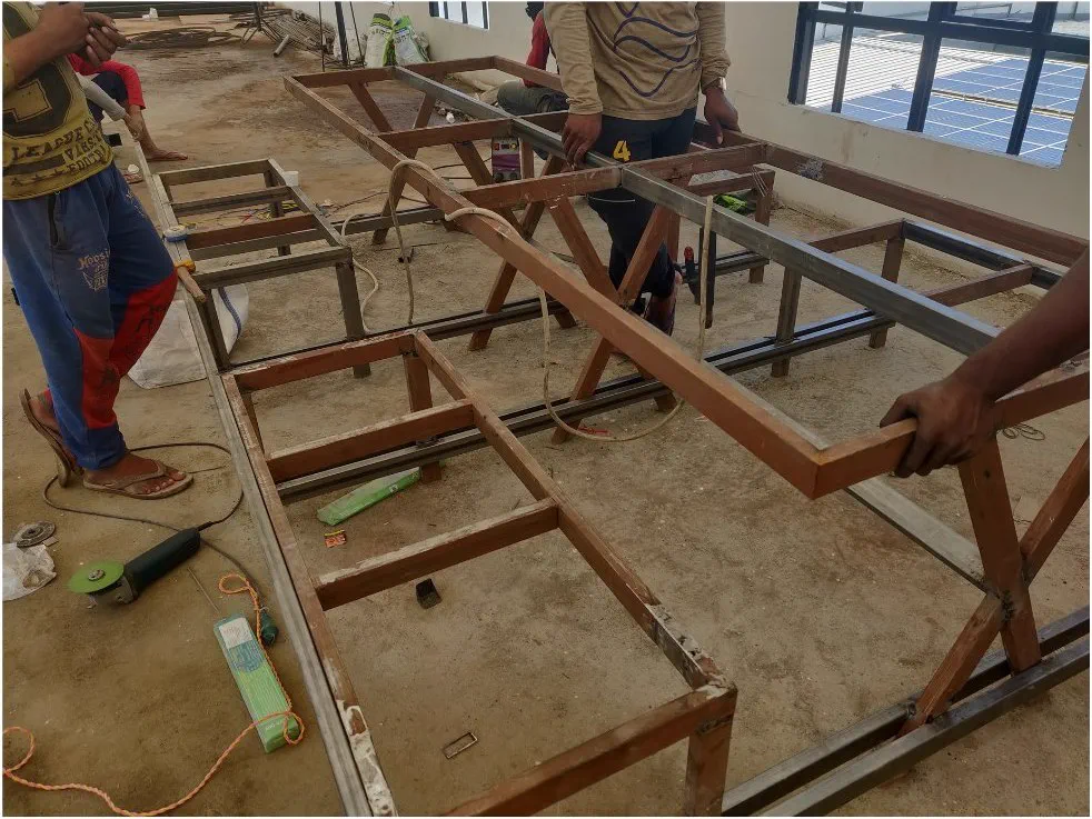 Carpenters assembling the terrace table frames on site