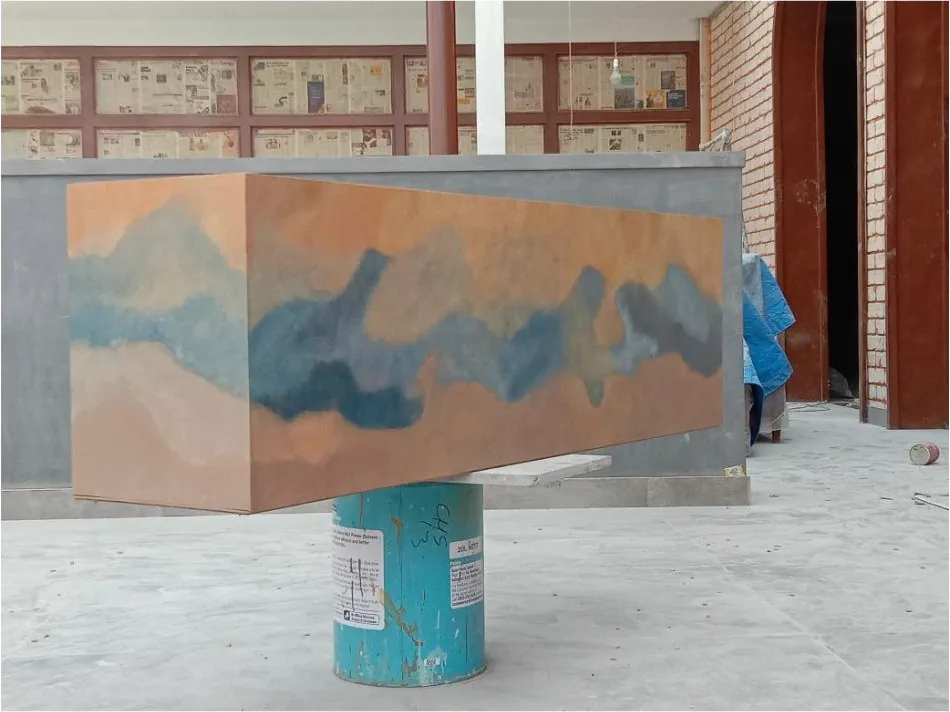 A finished duco-painted panel in orange and blue