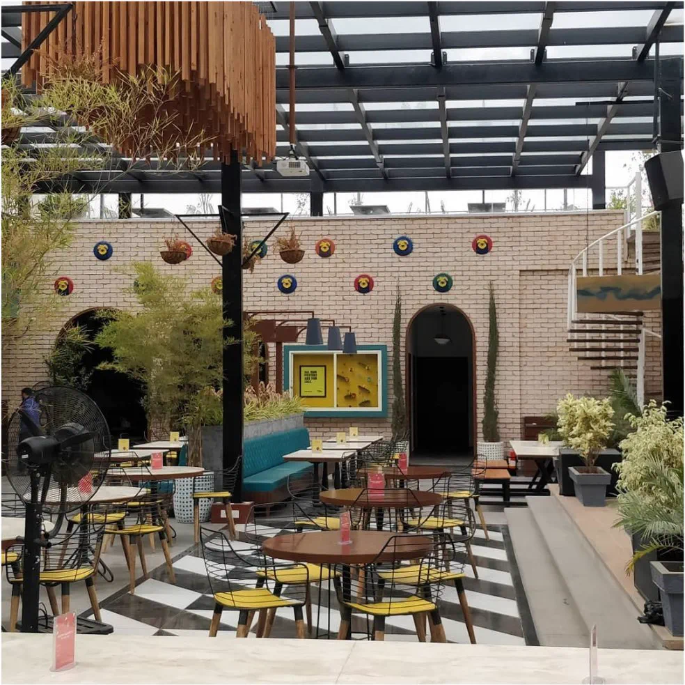 The open seating area with the spiral stair and hanging timber sculpture