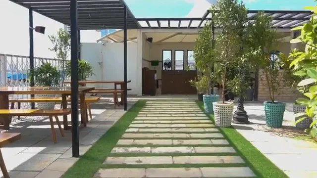 The open terrace with the custom tables under a pergola